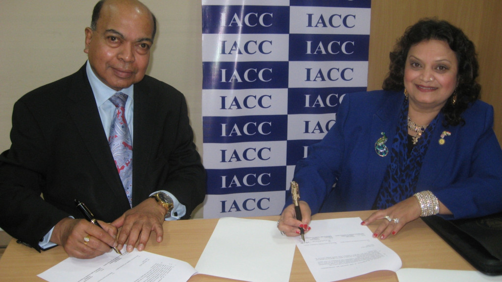 Mr. Asoke K Laha  President IACC signing the MOU with Ms. Purnima Voria  President NUICC