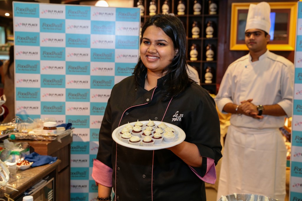 Chef Pooja Dhingra with her signature dessert Red Velvet Cupcakes