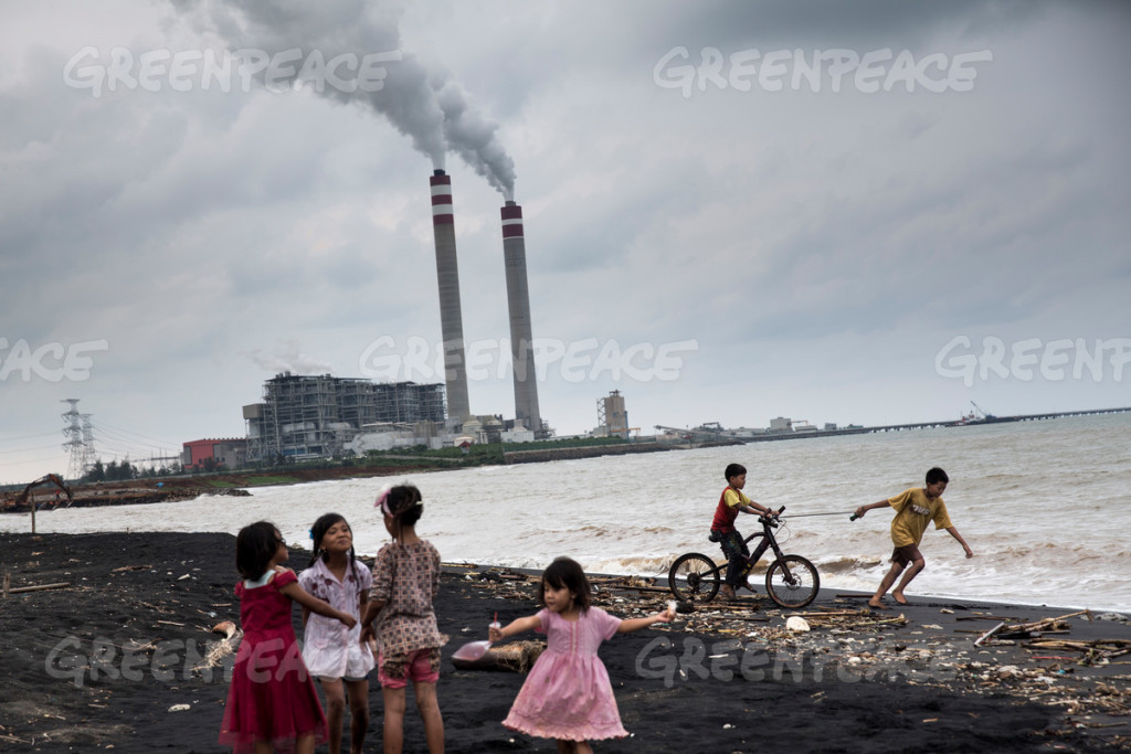 Children play by the beach near a coal power plant in Jepara, Central Java, oblivious to the possible threats to their health. The coal mining furore poses serious hazards to human health, the environment and the social integrity of communities around mining areas.