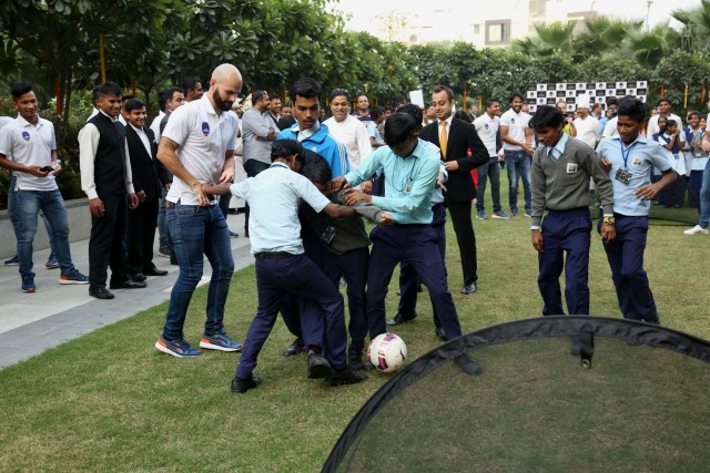 Kempinski Ambience Hotel team and Delhi Dynamos Team playing football with kids from Noida Deaf Society