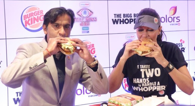 Mr Rajeev Varman CEO Burger King India with Neha Dhupia enjoying the The BIGG BOSS WHOPPER at Burger King store Andh_
