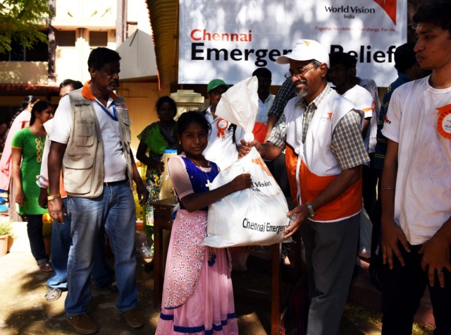 World Vision India's CEO and National Director Mr. Cherian Thomas distributing_
