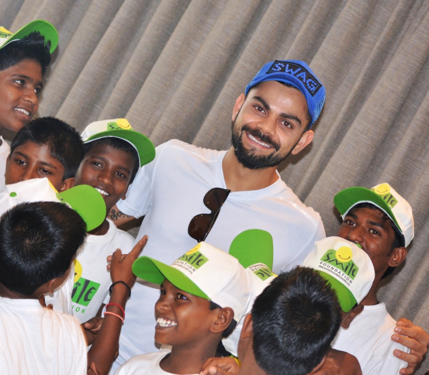 Virat Kohli sharing a smile with the Smile Foundation kids