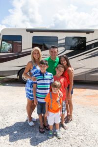 Host Buddy Valastro with his family in front of their RV at the Biscuit King and Fun Barn, as seen on Food Network's Buddy's Family Vacation, Season 1.