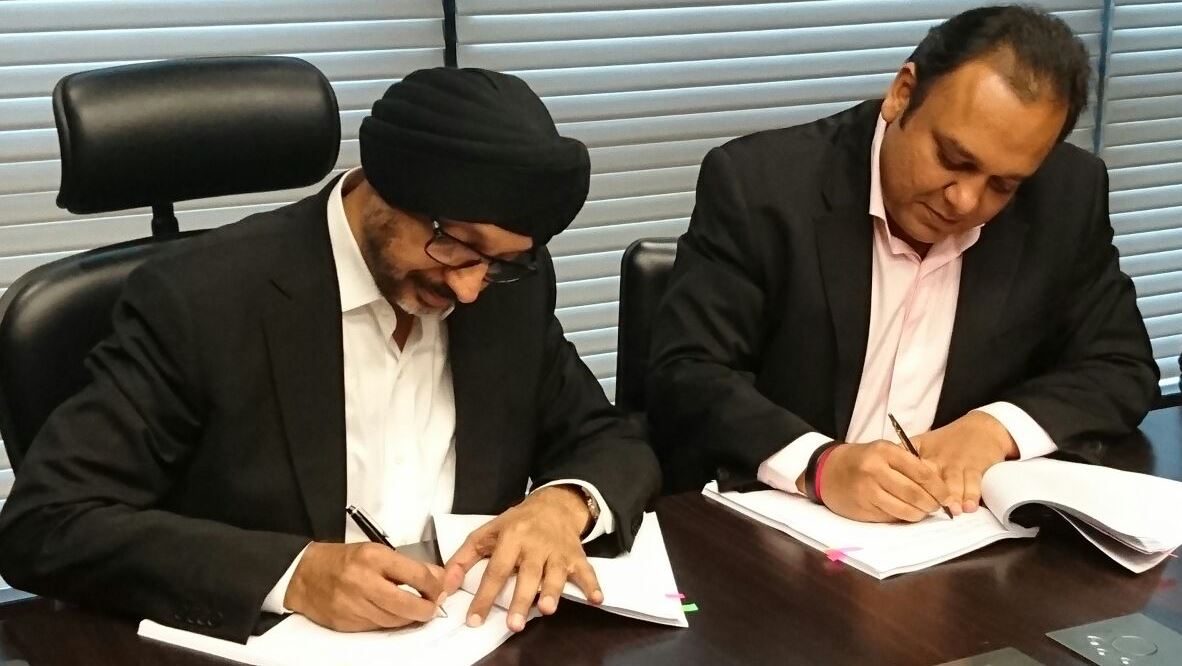 NP Singh and Punit Goenka signing agreements