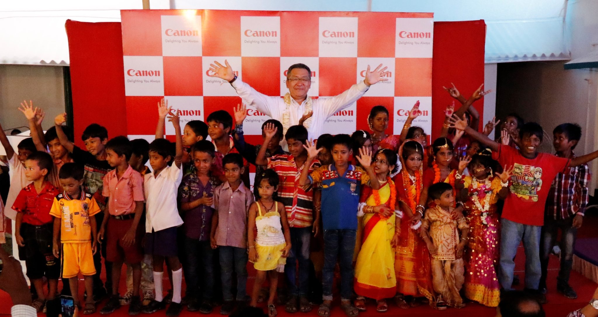 Mr. Kazutada Kobayashi  President & CEO  Canon India brings smiles to young faces at the first anniversary celebratio_